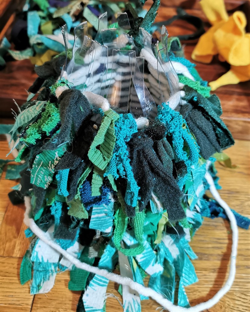 Nearly at the top, but how to finish? I ended up folding the plastic strips over and wildly improvising.